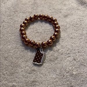 A brown charmed bracelet